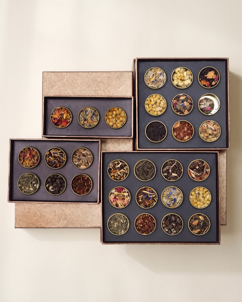 Kayatea Petite Boxes of three, six, nine and twelve tins on a warm cream backdrop