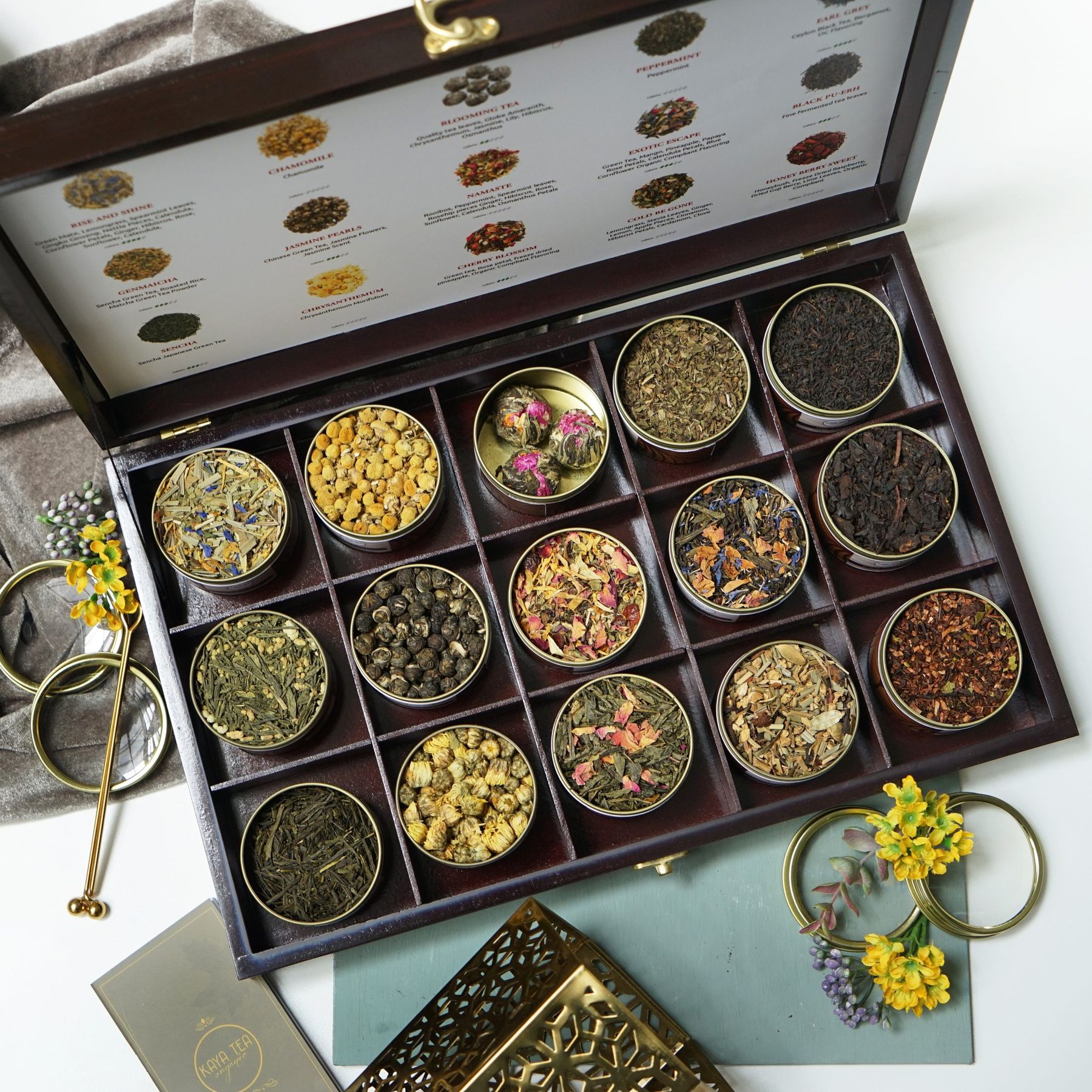 A Kayatea Wooden Box of twelve teas with dried flowers and gold ribbon