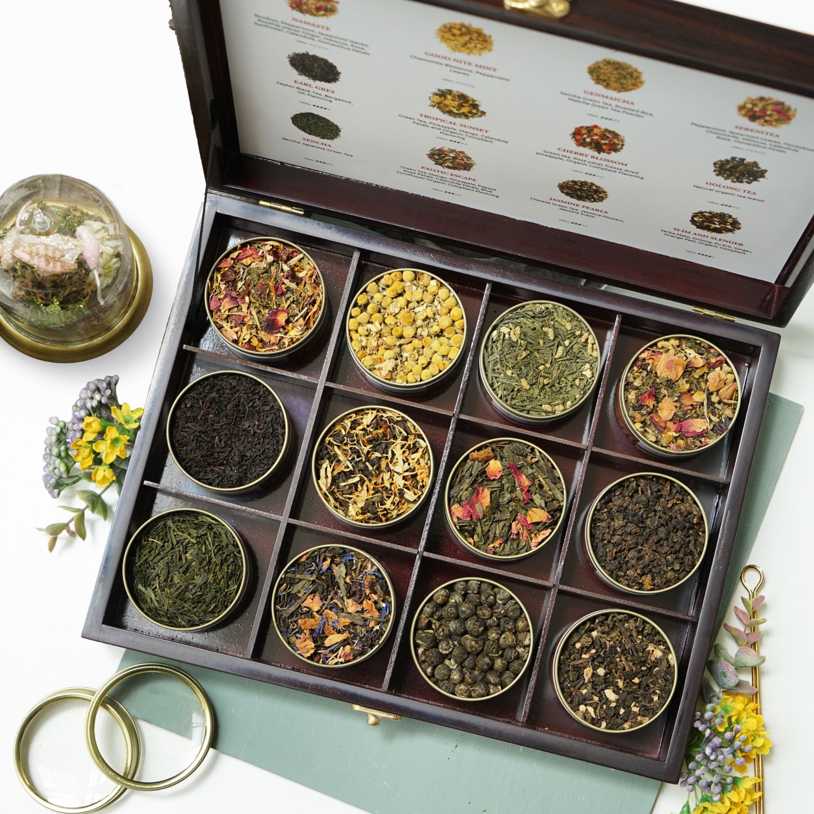The Kayatea Wooden Box open, with twelve tins of loose tea and fresh flowers